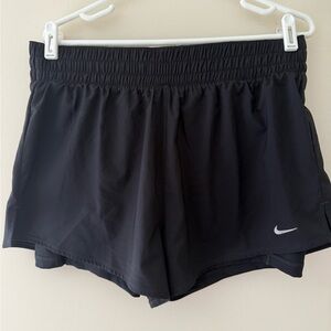 Women’s Nike Dri-Fit shorts with attached bike shorts. Size L.